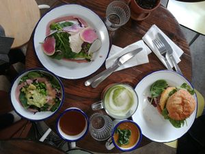 Avocado toast, mizuna salad, burger, soup, matcha latte at Aujourd'hui Demain Cafe in Paris