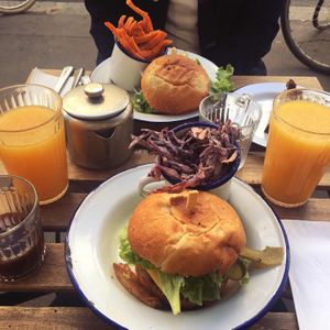 BLT burgers with peanut/chipotle coleslaw and sweet potato fries, + drinks included in the brunch   at Aujourd'hui Demain Cafe in Paris