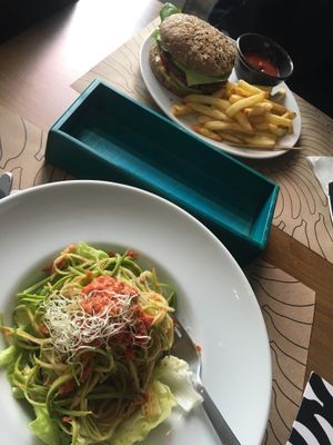 our lunch! Veggie burger and raw red sauce pasta. at Bananas Veggie & Raw Cuisine in Novi Sad