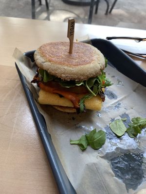 Breakfast Sammy - Pan fried English muffin, arugula, heirloom tomato, cashew sriracha hollandaise, carrot bacon and just egg patty. Incredible!   at Fox & Fig in Savannah