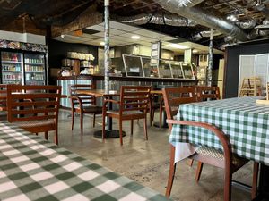 Interior, employee visibly smiling at Murray Hillbilly in Jacksonville