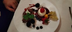 Dessert: Variation von Panna Cotta auf einem Himbeerspiegel, Mousee au chocolat und frischem Obst at Alex Kitchen in Heide