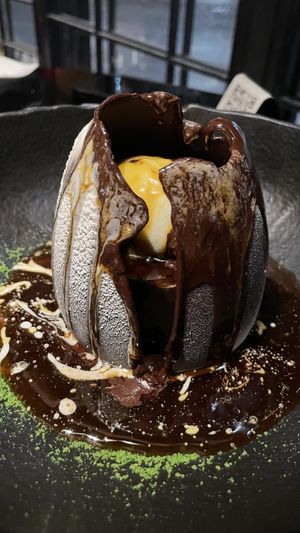 The chocolate egg filled with dreams (or a chocolate cream tarte and vanilla ice cream), melted by caramel sauce   at Wild Food in Granada