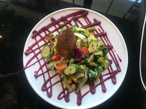 The Garden .) Peas, green asparagus, bell-pepper, pak choi, cherry tomatoes and zucchini topped with  beetroot sauce, crispy millet and black garlic  at Wild Food in Granada