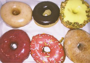 top left glaze, chocolate, pistachio, bottom left blueberry raspberry with sprinkles, & cinnamon.  at Revolution Doughnuts in Atlanta
