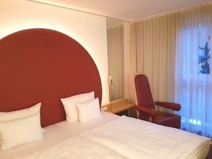 Bed in a standard room  at Arcotel Rubin in Hamburg