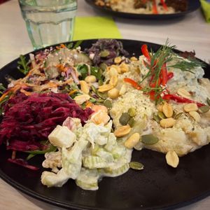 Falafel loaf on garlic potatoes, with waldorf salad, beetroot salad, ginger-sesame beans and veggies (13,50e) at Anne's Vege in Espoo