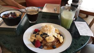 Pancakes, matcha latte and coffee. at TICH Healthy Living in Brussels