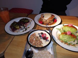 Cashew toast, avocado toast, sunny bowl and pancakes.   at TICH Healthy Living in Brussels