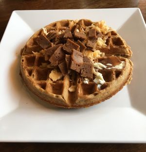 Vegan Bacon Cheddar waffle. Nice smokey flavor that pairs nicely with maple syrup and vegan butter. at The Buzz Coffee & Cafe in Burnsville