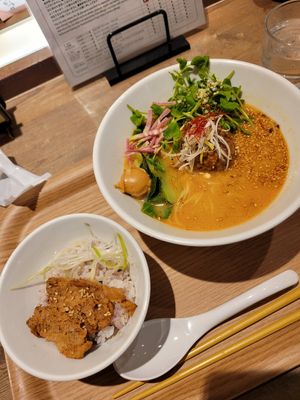 Golden sesame ramen with bowl of rice and soy meat at T's Tantan - JR Ueno in Tokyo