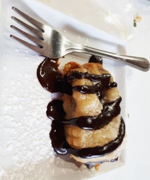 Pancake fried ice cream sandwich...ice cream sandwich fried in delicious funnel cake-like dough and topped with fudge sauce.  at Mythology in Toronto