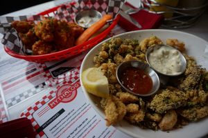 Oyster Mushroom Calamari with Dill Sauce and Buffalo Boneless Wings at Mythology in Toronto