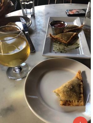 Fried cashew cheese ravioli with pesto and marinara and dry cider  at City O' City in Denver