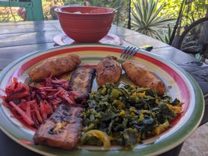 A very tasty vegan porridge, callaloo, fried plantains, cornmeal biscuits,  and other delights for breakfast. at Ini Ital Rastarant in Negril