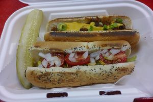 Duo of Dogs (Chicago & Chili Cheese):
Grilled Young Carrots on Poppy Seed Bun

Duo 1:
Pepperoncini
Cherry Tomatoes
Diced Onions
Pickled Spear
House Ketchup, Mustard

Duo 2:
Chili
Not-Yo Cheese
Green Onion at Lil' Lotus in Salt Lake City