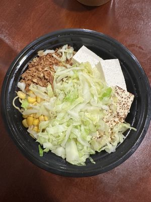 Slurp spicy before broth with tofu, cabbage, corn, and crispy onions  at Slurp Ramen in Port Jefferson