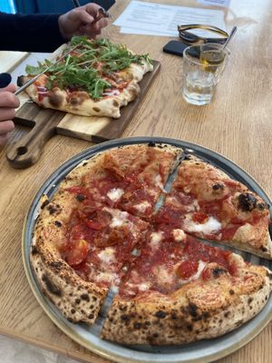 Canotti marinara with added feta in front, a pinsela pizza in the back.   at Vegazzi Specialty Pizzeria in Budapest