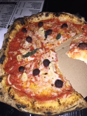 pizza of the day with cheese and meatballs , a lot less basil than advertised at Vegazzi Specialty Pizzeria in Budapest