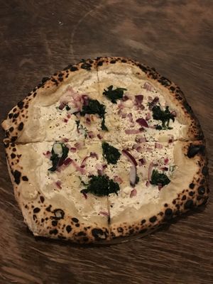 Sourdough pizza with “sour cream”, tofu, garlic, arugula and red onion at Vegazzi Specialty Pizzeria in Budapest