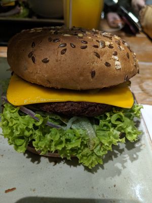 Vegan burger with fried onions and garlic and add-on of pickles at Hans im Glück in Central Singapore