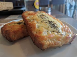 Crispy with more salty herb flavor than garlic- but very good! at Slices in Osaka
