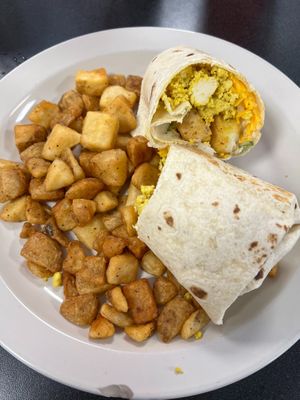 Loaded Vegan Breakfast Burrito with a Side of Spuds- 12in Wrap Stuffed with Spuds, Grilled Onions, Bell Peppers, Tofu Eggs, Vegan Mayo, and Daiya Mozzarella at Ocala's Downtown Diner in Ocala