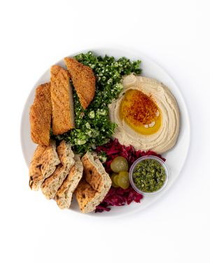 Meatless Schnitzel platter.
serve with Tabbouleh salad, hummus, red vinaigrette cabbage, pita, schug , pickles. at The Hummus House in Fort Lauderdale