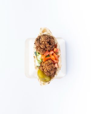 Crispy Cauliflower pita.
serve with hummus, cucumber, tomato, pickles, schug, tahini sauce at The Hummus House in Fort Lauderdale