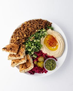 Spicy "Beef" Platter:
serve with tabbouleh salad, hummus, pita, red cabbage, pickles, schug( hot sauce) at The Hummus House in Fort Lauderdale