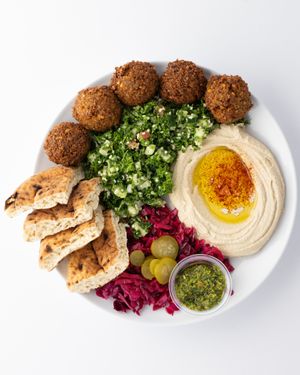 Falafel Platter: serve with Tabbouleh salad, red cabbages, pita, Hummus, pickles, schug ( hot sauce) at The Hummus House in Fort Lauderdale