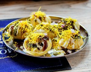 Delicious Indian style taco shells bursting with flavour, filled with chick peas, potatoes and red onion topped with homemade chutneys, spicy yogurt  and sev.  at Jaldee Jaldee in Brighton