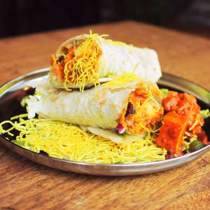 Paneer or tofu pieces infused with whole Indian spices marinated in our special tomato sauce, topped with raw red onions and homemade chutneys, served in a warm Indian flatbread.  at Jaldee Jaldee in Brighton