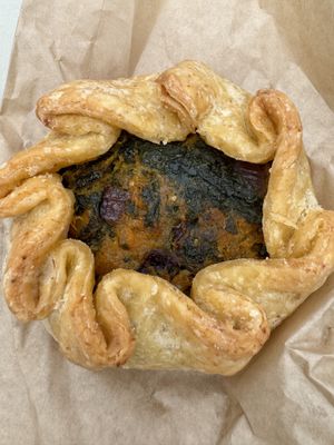 Vegan squash galette from Grains bakery  at Capitol Hill Sunday Farmers Market in Seattle