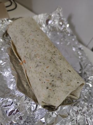 Big spinach wrap with lettuce, lentils, corn, tomato, green pepper, vegan dressing, and more at Cocome in Sevilla