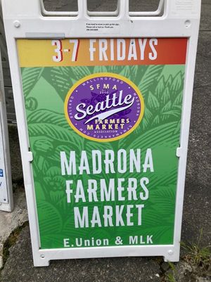 Exterior- sandwich board with hours and location  at Madrona Farmers Market in Seattle