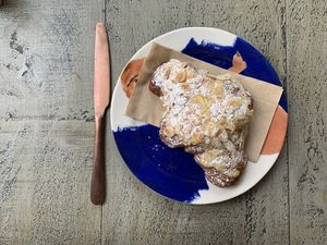 Almond croissant  at East Village Cafe in Bristol