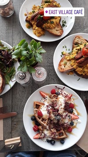 Waffles & tofu scramble topped with tempeh at East Village Cafe in Bristol
