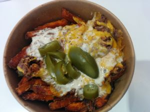 Spicy loaded sweet potato fries - Chopped Black Bean Patty, melted Cheddar Style Cheese, Jalapenos and Creamy Horseradish Sauce. Easily a delicious meal on its own at Next Level Burger - Concord in Concord