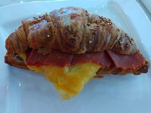 Vegan bacon, egg and cheese breakfast sandwich on multigrain croissant at Angelic Desserts in Naples