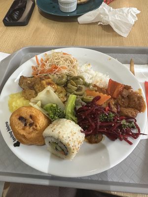 Fried cauliflower, 2 sushi pieces, rice noodles, white rice, curried tofu and seitan, veggies, mashed potatoes, beet salad, and green olives  at Loving Hut - Spalena in Prague