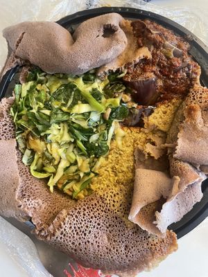 Injera bowl as takeout with eggplant, collards and lentils   at Flavors of East Africa in San Diego