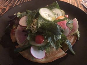 Chickpea pancake topped with salad.  Tasty but heavy.  Best thing I tried.  at XYST in New York City