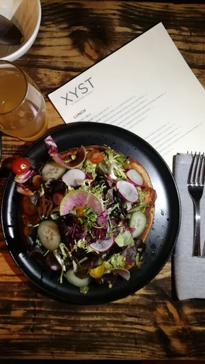 CAST IRON SOCCA. MARKET GREENS. GREEN HERB PUREE. AVOCADO. USD16 at XYST in New York City