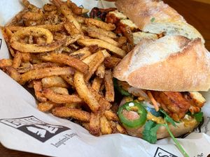 Tempeh Bahn (sic) Mi: Kimchi-Avocado Spread, Pickled Carrots, Daikon, Cucumber, Jalapeno w/ French Fries at Bell's Brewery in Kalamazoo
