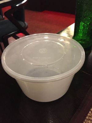 Big plastic container offered for leftovers at Goodsouls Kitchen in Chiang Mai