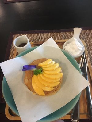 Banana pancakes with mango - comes with coconut whipped cream and syrup... SO GOOD at Goodsouls Kitchen in Chiang Mai
