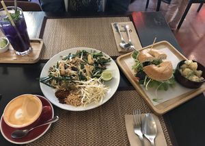 Right to left - Bagel sandwich with soy cream cheese, Pad Thai, Thai tea with soy milk, butterfly pea soda at Goodsouls Kitchen in Chiang Mai