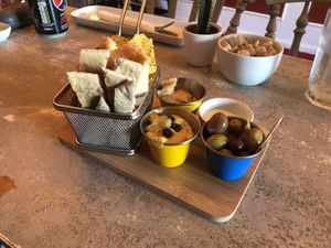 Tapas round 1 - double hummus, garlic dip and olives with various breads and tortilla chips at Sundowners in Exmouth