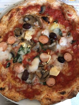 “Picciotta” pizza with rice mozzarella, vegan sausage, tomato, artichokes and olives - wholemeal and chickpea flour dough  at Rossopomodoro in Trieste